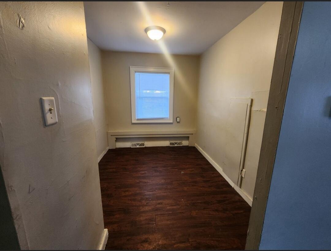 3515 164th Street Hammond, IN 46323 - Photo 7 of 12 a view of a hallway with wooden floor and a bathroom