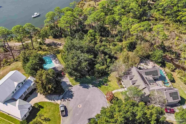 an aerial view of a residential houses with outdoor space and street view