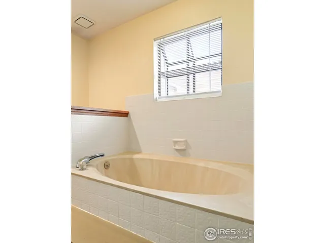 a white bath tub sitting next to a window
