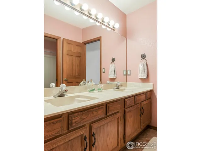 a bathroom with a double vanity sink and a mirror