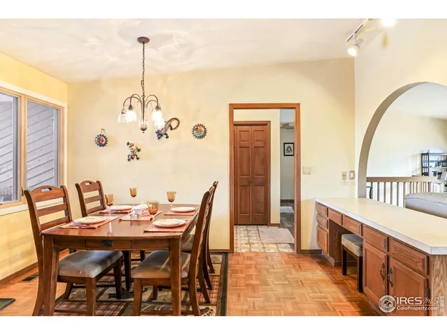 a view of a dining room with furniture and chandelier