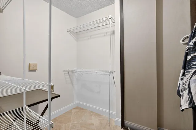 a bathroom with a sink a toilet a mirror and shower