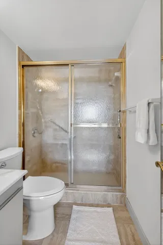a bathroom with a sink vanity mirror and toilet