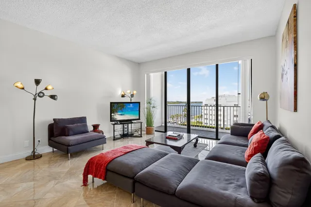 a living room with furniture and a floor to ceiling window