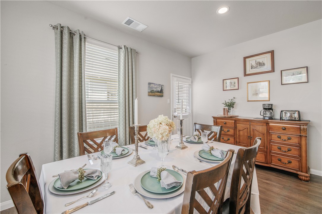 4703 Coyotillo Way Bryan, TX 77807 - Photo 10 of 24 a view of a dining room with furniture window and wooden floor