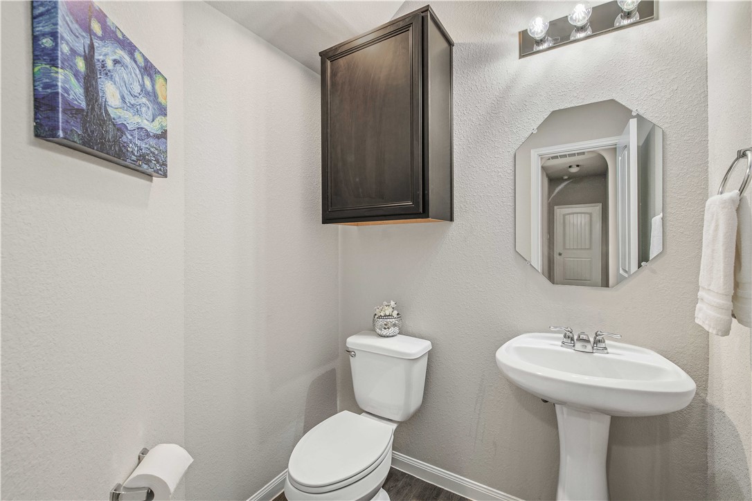 4703 Coyotillo Way Bryan, TX 77807 - Photo 12 of 24 a bathroom with a toilet sink and mirror