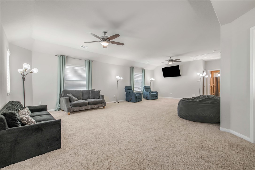 4703 Coyotillo Way Bryan, TX 77807 - Photo 14 of 24 a living room with furniture and a flat screen tv