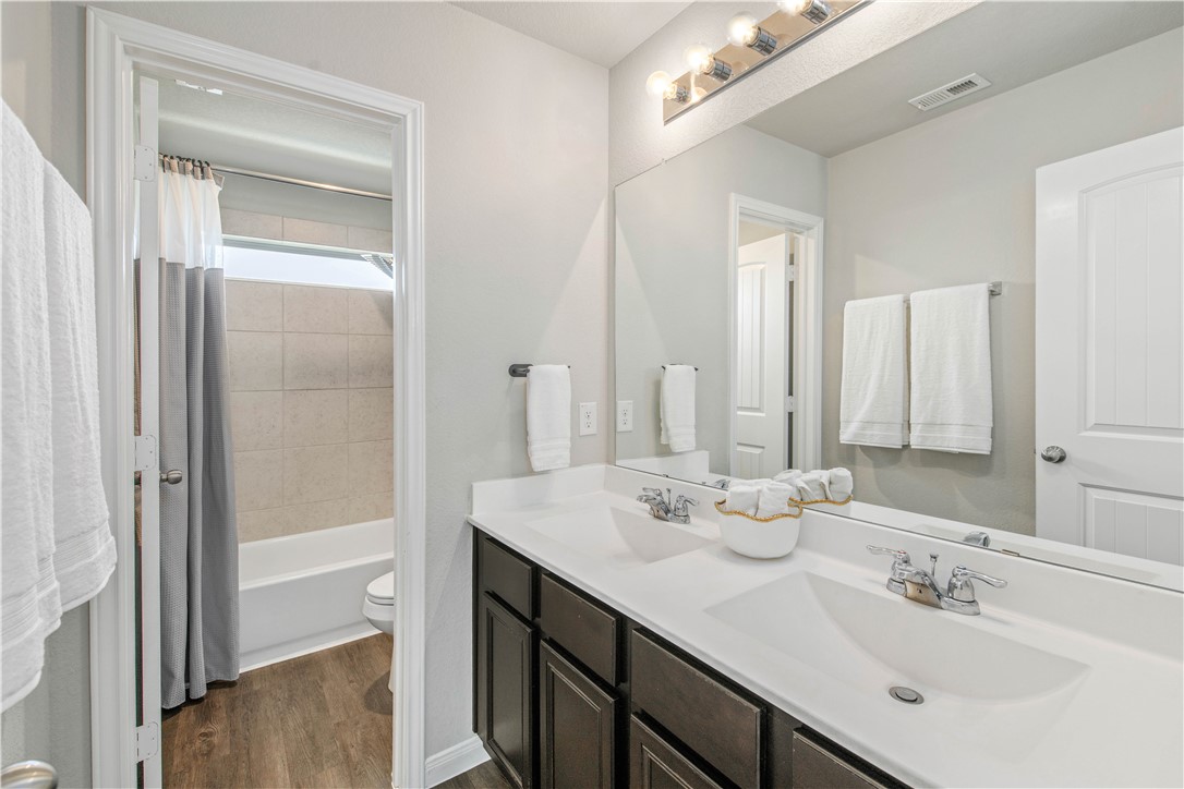 4703 Coyotillo Way Bryan, TX 77807 - Photo 20 of 24 a bathroom with a double vanity sink mirror and double