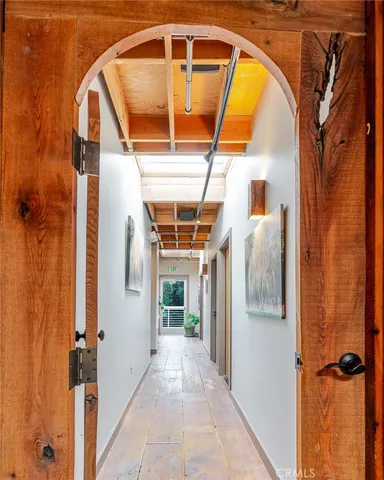 a living room with furniture kitchen view and a potted plant