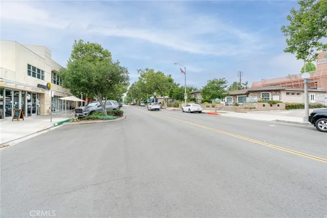 a view of a patio with table and chairs potted plants with wooden floor