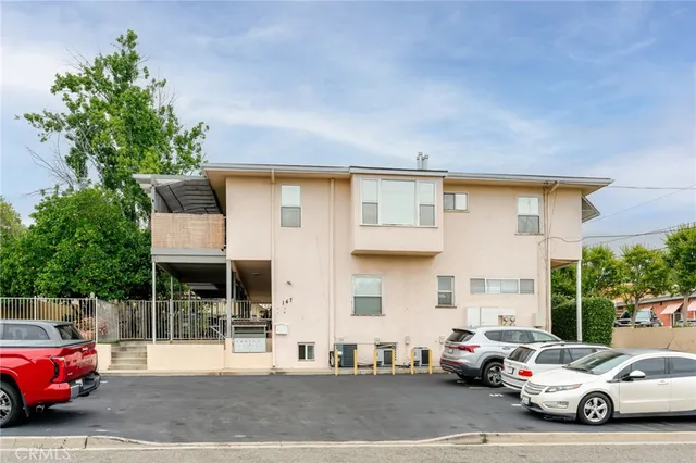 a view of entryway with wooden floor and a front door