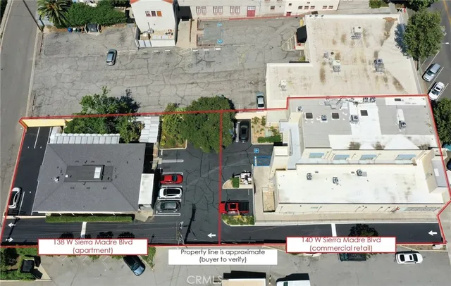 a view of a building with a patio and a yard