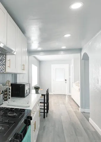 a kitchen with sink stove and cabinets