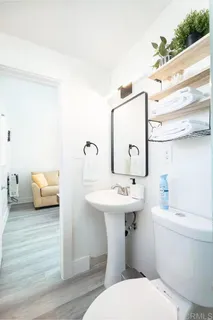 a bathroom with a sink toilet and mirror