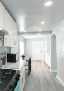 a spacious bedroom with a bed and a table in it