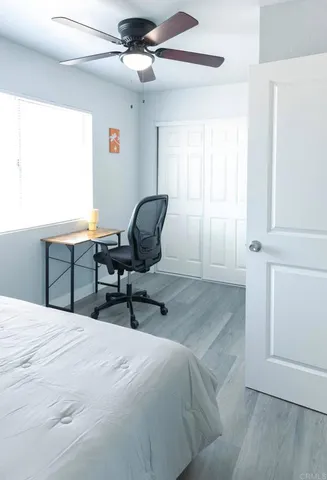 a bedroom with a bed a desk and chair