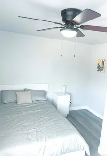 a bedroom with a bed and ceiling fan