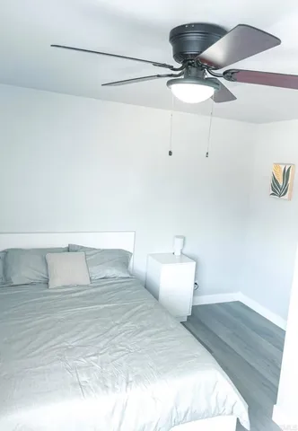 a bedroom with a bed and ceiling fan