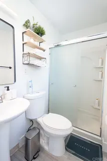 a bathroom with a toilet a sink and shower