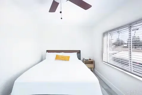 a bedroom with a bed and a window