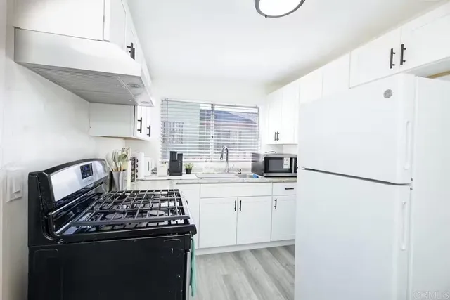 a kitchen with a sink a stove and refrigerator