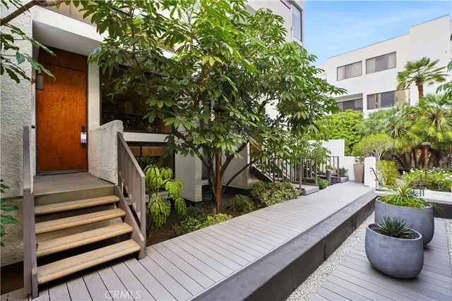 a view of a two chairs and table in the balcony