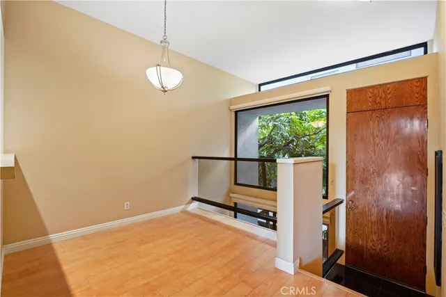 a view of a room with wooden floor and windows