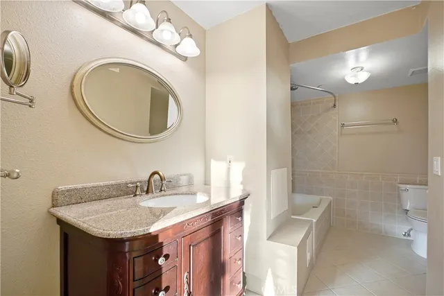 a bathroom with a granite countertop sink a mirror and a shower
