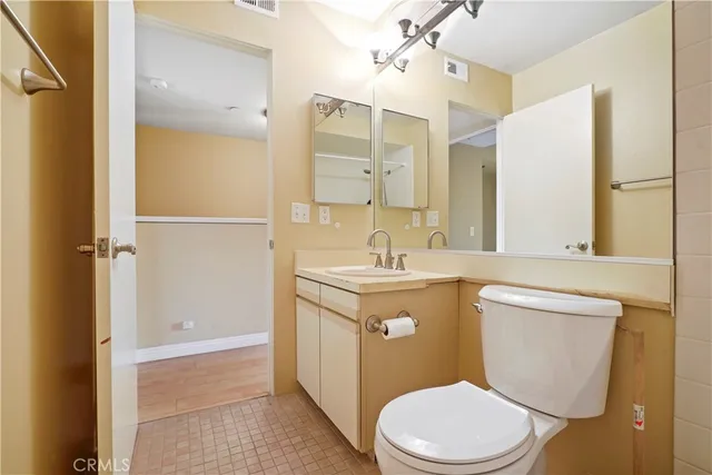 a bathroom with a sink a toilet a mirror and shower