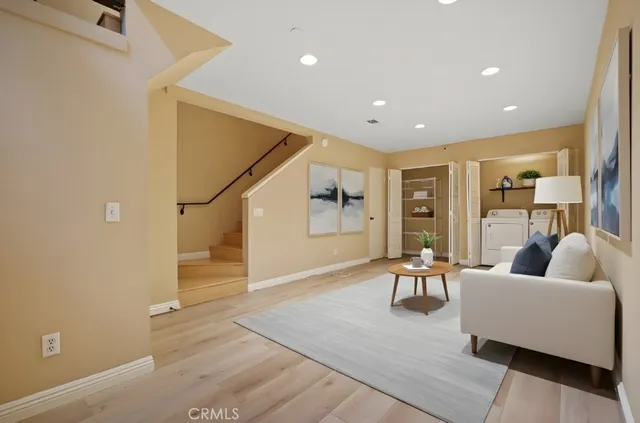 a living room with furniture and wooden floor