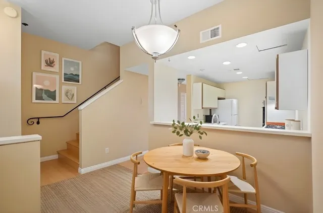 a dining room with furniture and wooden floor