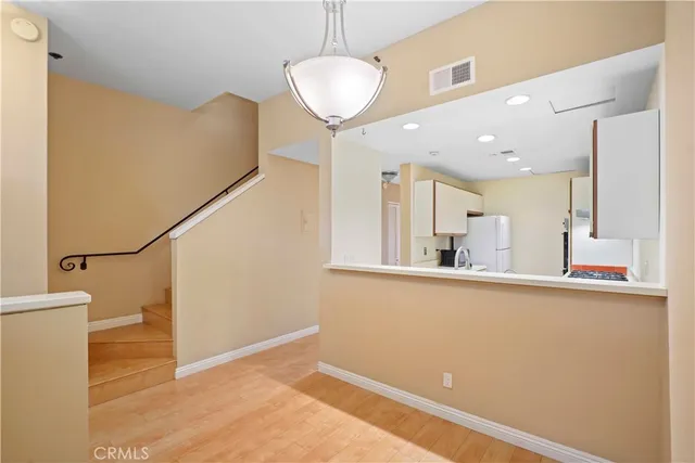 a view of a room with wooden floor and staircase