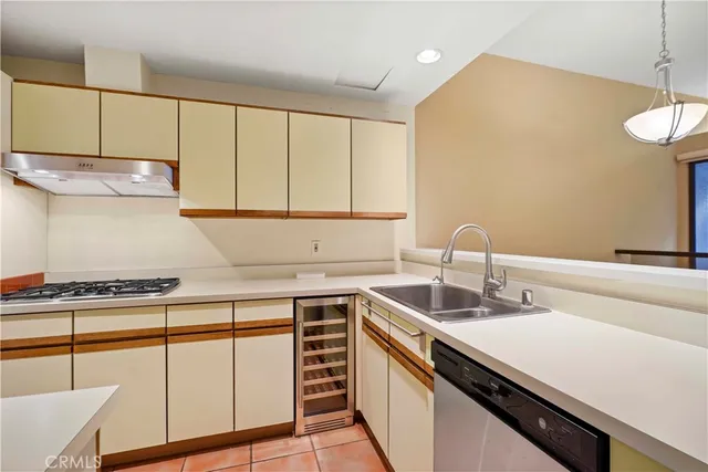 a kitchen with a sink cabinets and stainless steel appliances