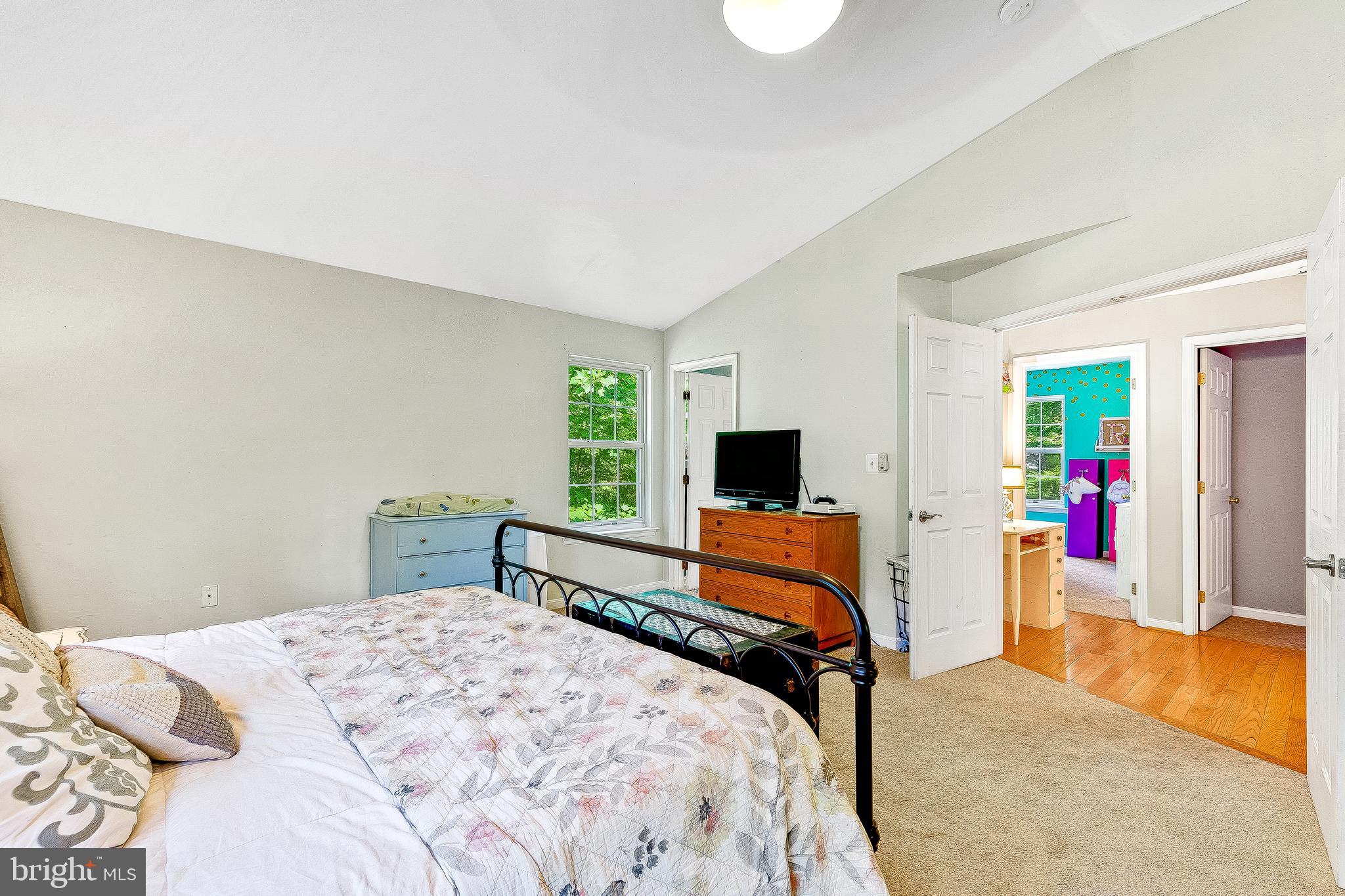 11356 Redlands Road Lusby, MD 20657 - Photo 12 of 36 a bedroom with a bed and a flat screen tv