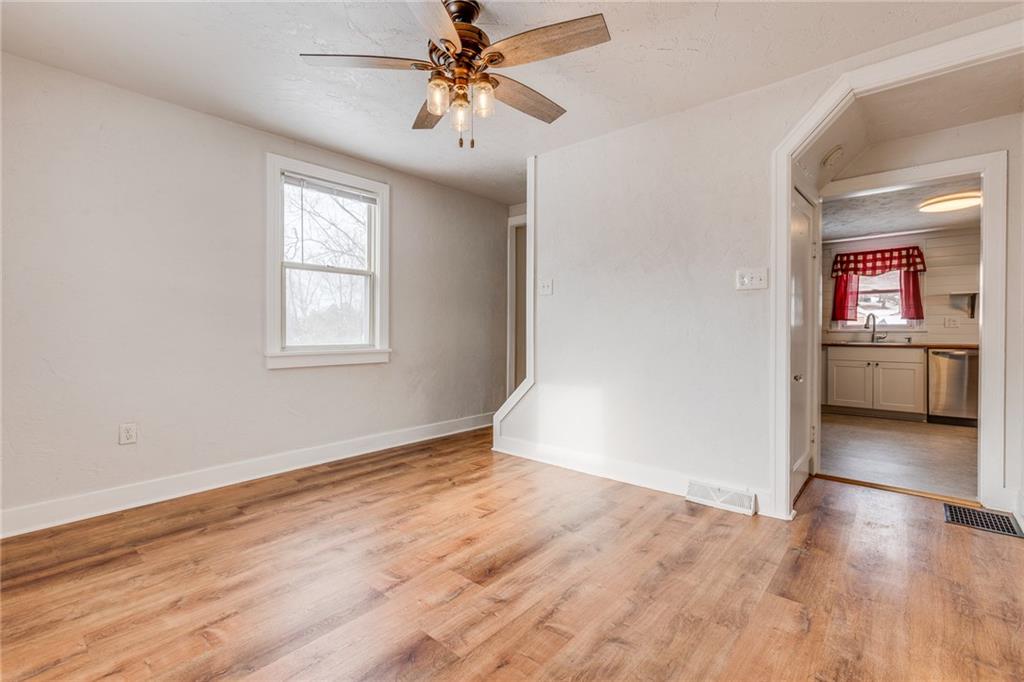 11561 Center Street Irwin, PA 15642 - Photo 14 of 46 wooden floor in an empty room with a window