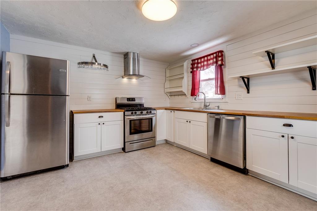 11561 Center Street Irwin, PA 15642 - Photo 16 of 46 a kitchen with white cabinets sink and white appliances