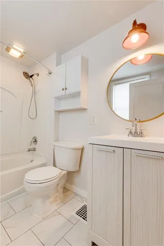a bathroom with a toilet a sink and bathtub