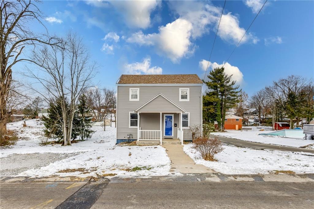 11561 Center Street Irwin, PA 15642 - Photo 2 of 46 a front view of a house with a yard and covered with snow