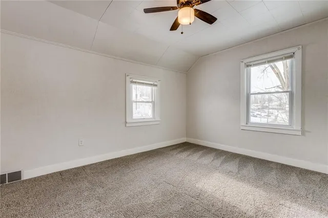 a view of a livingroom with a ceiling fan and window