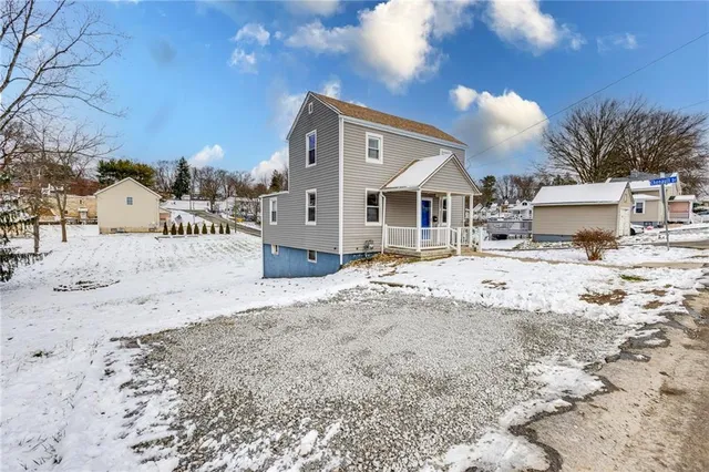 a view of a house with snow on the road