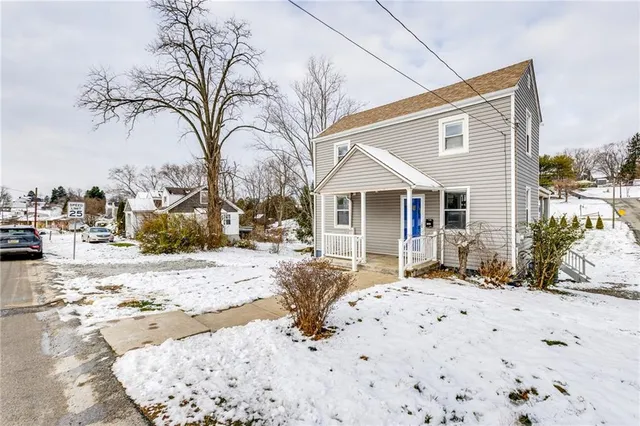 a view of a house with a snow on the road