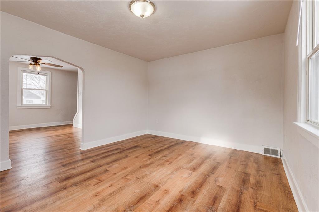 11561 Center Street Irwin, PA 15642 - Photo 7 of 46 an empty room with wooden floor and windows