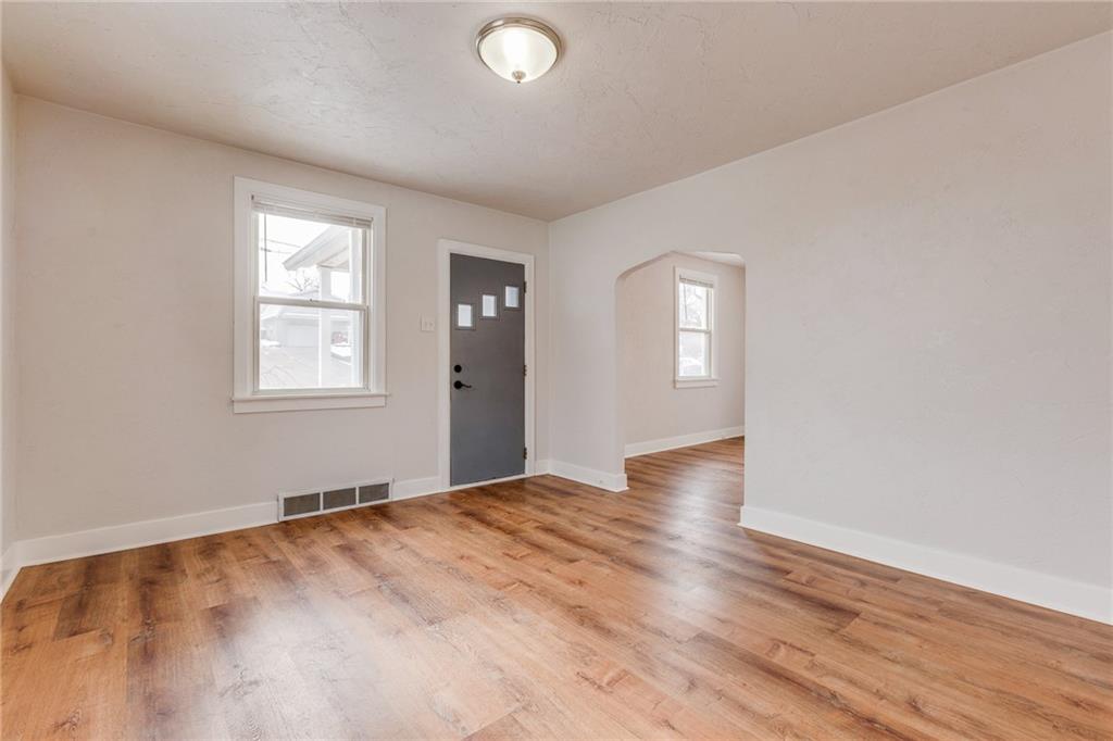 11561 Center Street Irwin, PA 15642 - Photo 8 of 46 a view of an empty room with wooden floor and a window
