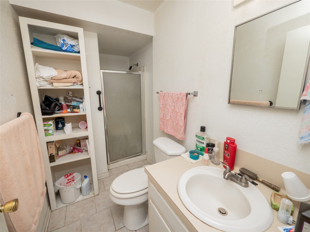 1409 Zephyr Road Killeen, TX 76541 - Photo 14 of 31 a bathroom with a sink vanity mirror and toilet