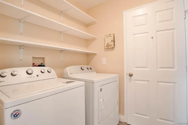 a view of storage and utility room with washer and dryer