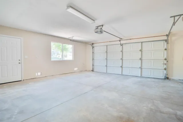 an empty room with a empty space and windows