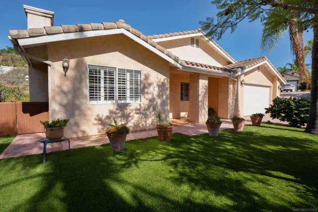 a front view of a house with a yard table and chairs
