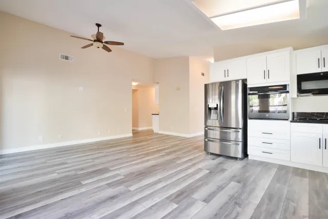 a kitchen with stainless steel appliances a refrigerator and cabinets