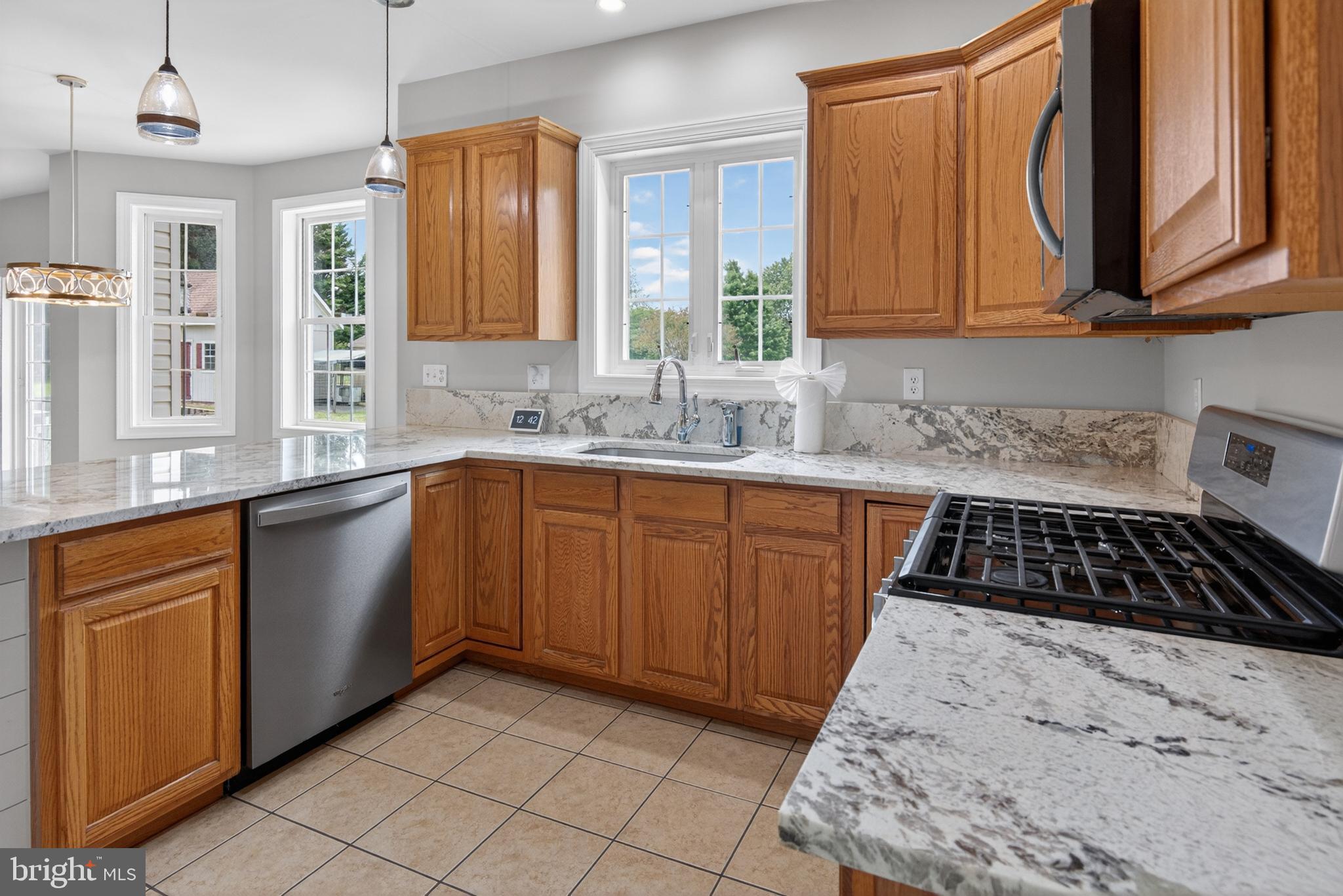 337 Roe Ingleside Road Centreville, MD 21617 - Photo 21 of 56 a kitchen with stainless steel appliances a sink stove and cabinets