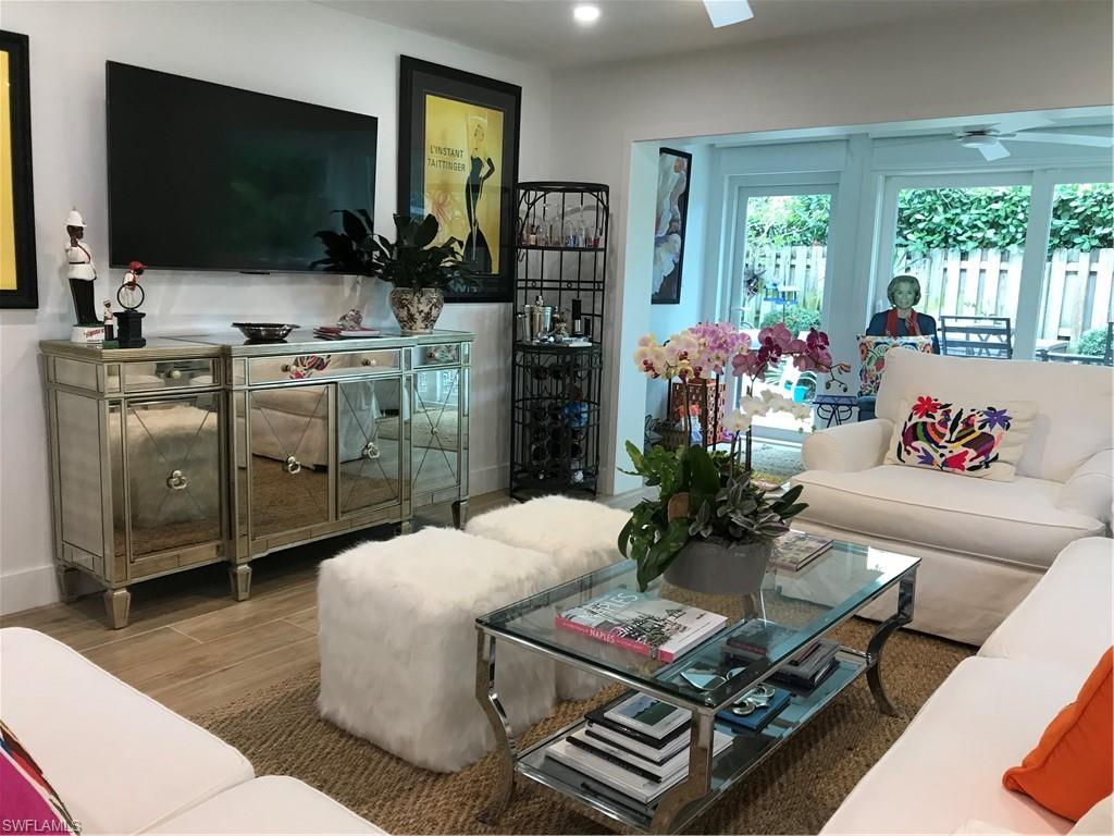 302 2nd Street South, Unit 302 Naples, FL 34102 - Photo 1 of 14 a living room with furniture and a flat screen tv